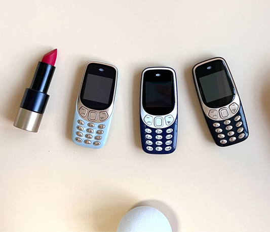 Three vintage-style mobile phones and a lipstick on a light background with 'COLOR DETAILS' text.