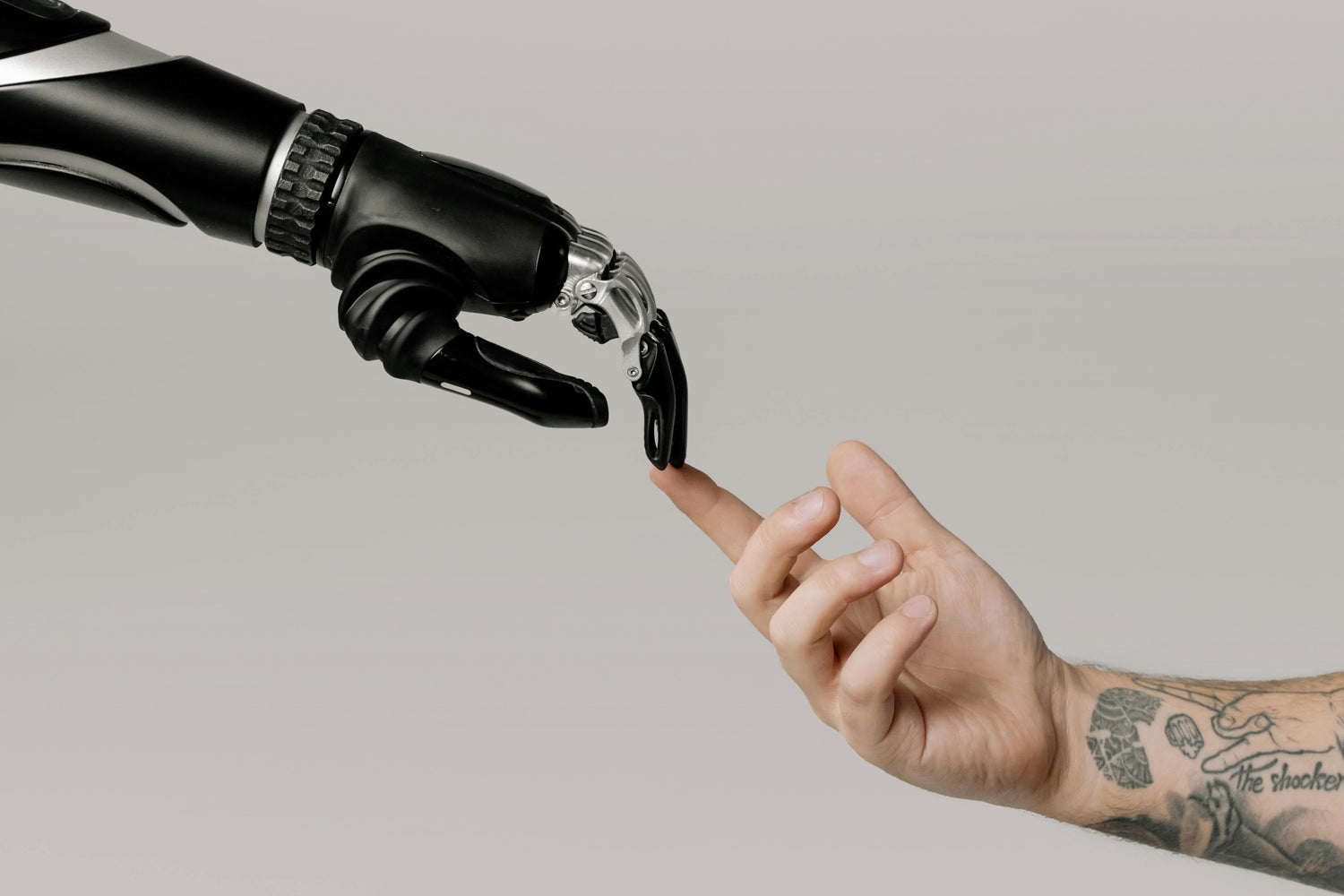 Robot hand touching a human finger against a neutral background. TokenPi Store